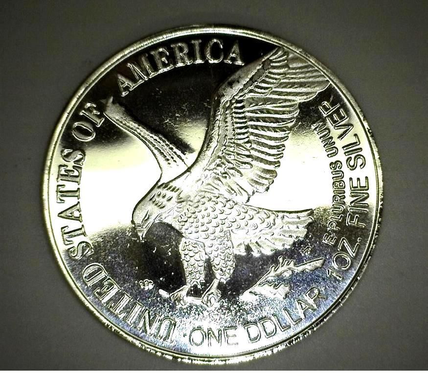Silver U.S. dollar coin with an eagle in flight, 
