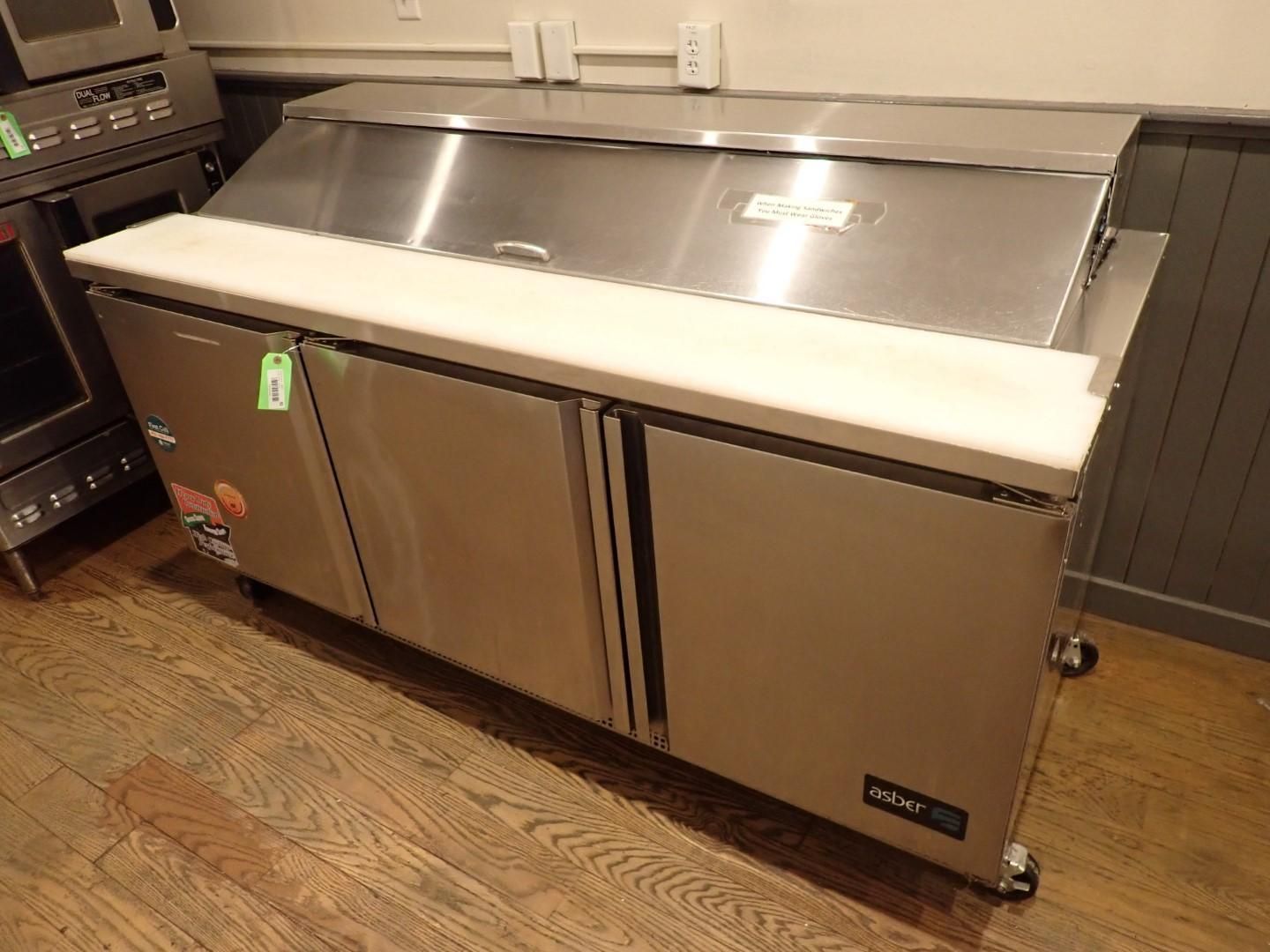 Stainless steel refrigerated sandwich prep table with cutting board top.