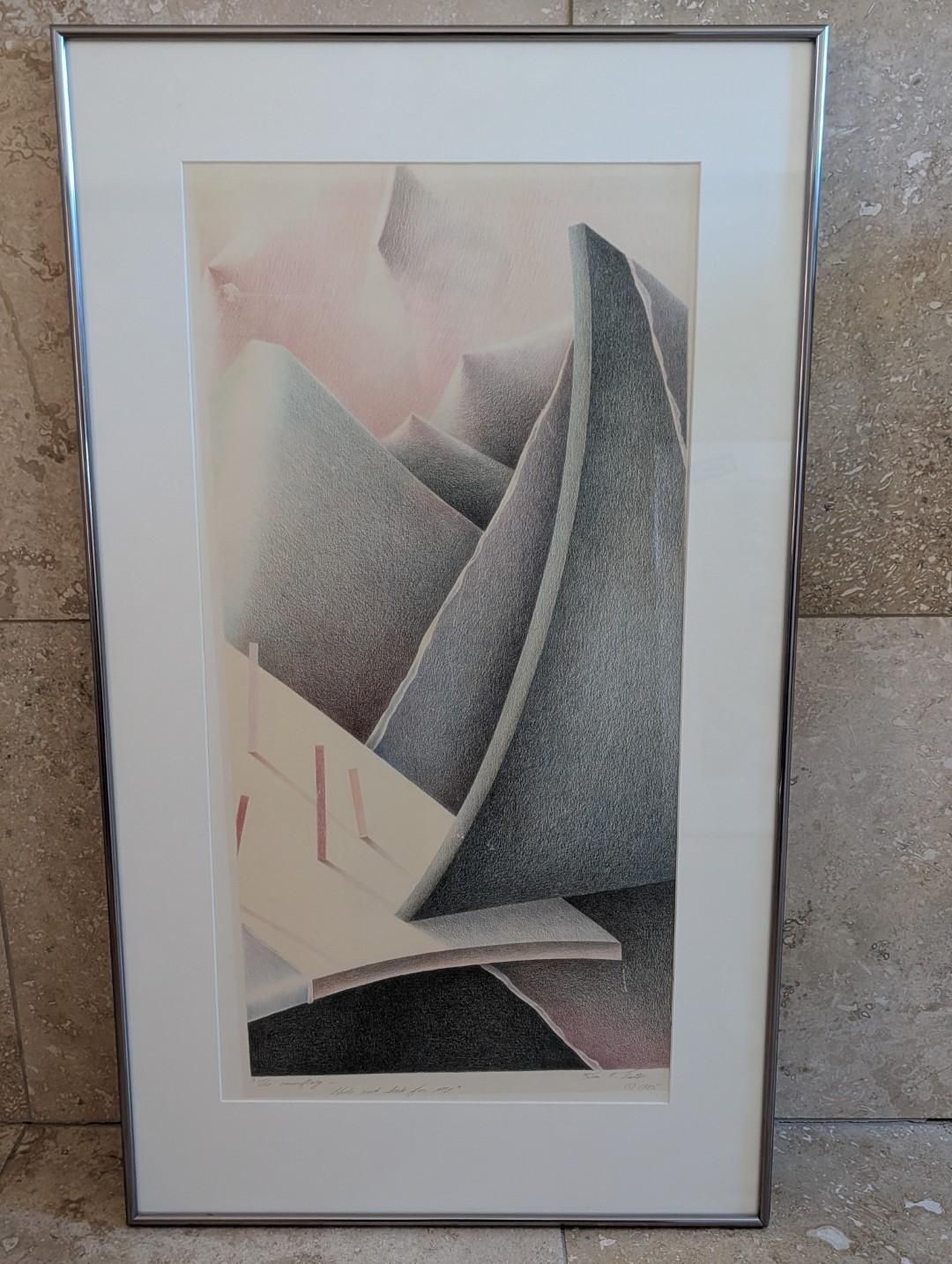 Framed abstract artwork with geometric gray, beige, and pink shapes on a light wall.