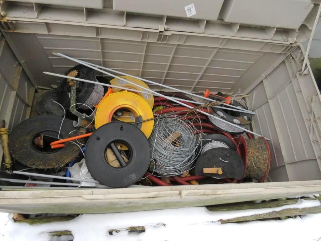Open plastic storage bin filled with various items.