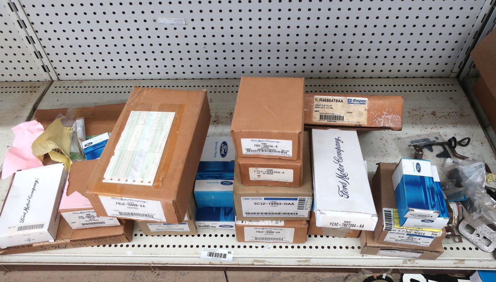 Boxes of various sizes stacked on a shelf. Some have labels.