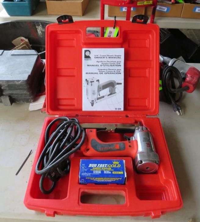 Red toolbox open, containing a stapler, staples, and instruction manual.