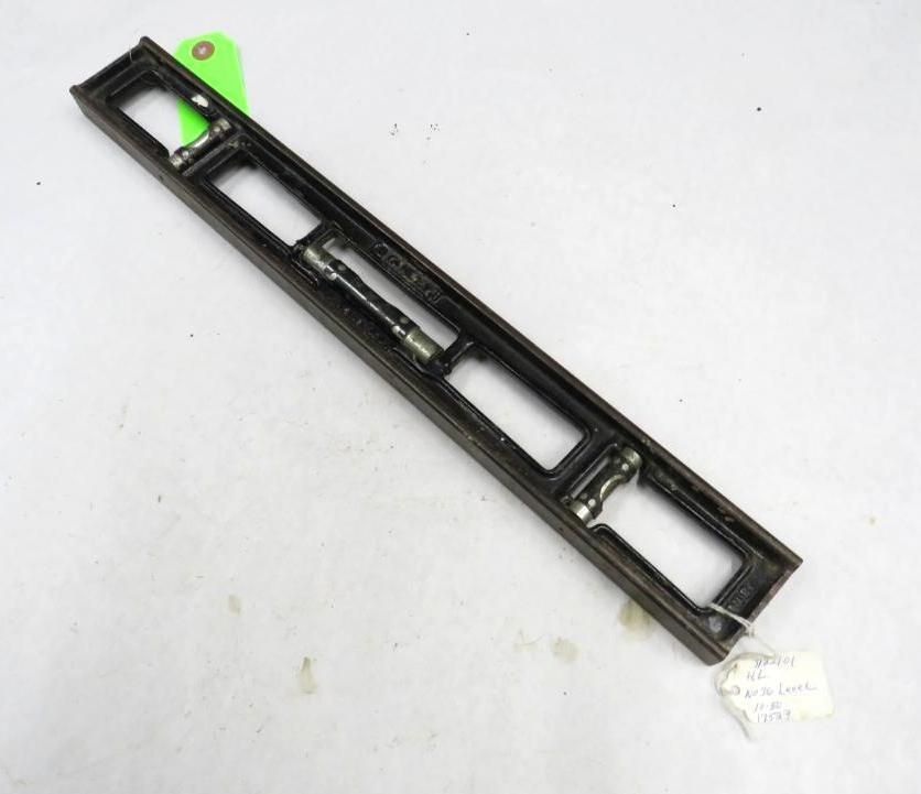 Black level tool with three bubble vials. Green tag on top, white tag on bottom.