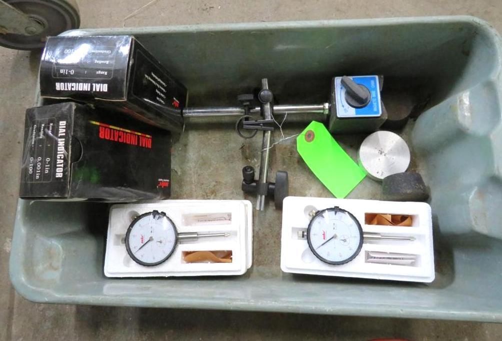 Toolbox with dial indicators, magnetic base, and parts.