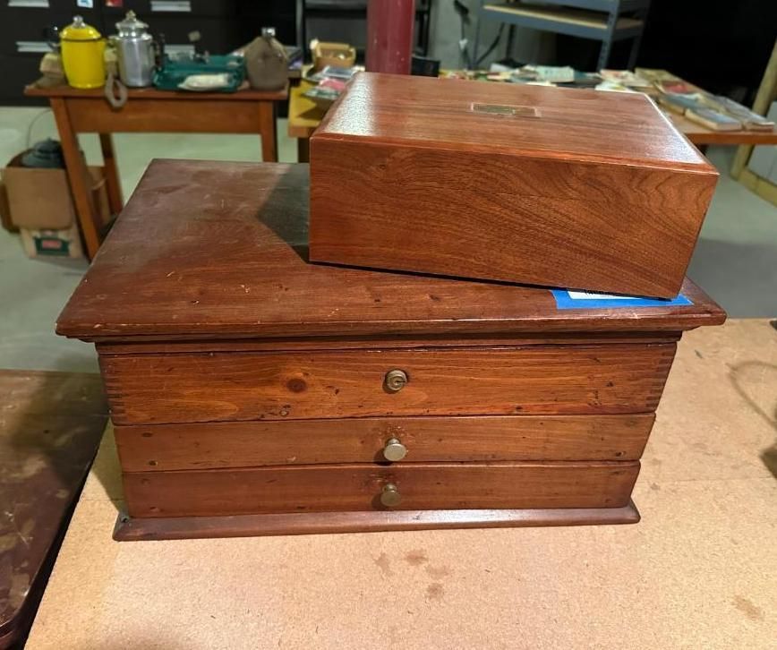 Two wooden boxes: one with drawers, the other atop it.