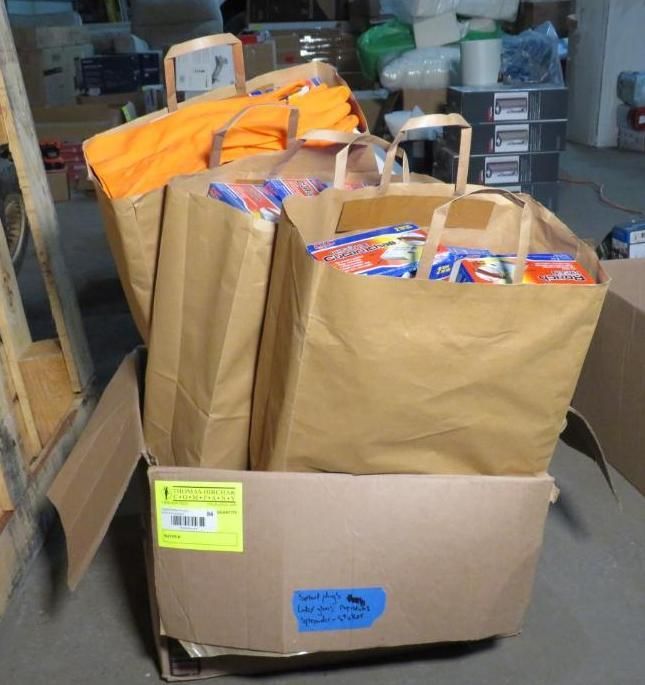 Brown paper bags filled with kitchen items inside a cardboard box.