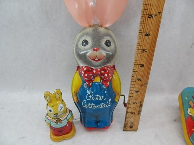 Tin toys: Peter Cottontail, wind-up bunny, and small bunny figure. All are brightly colored.