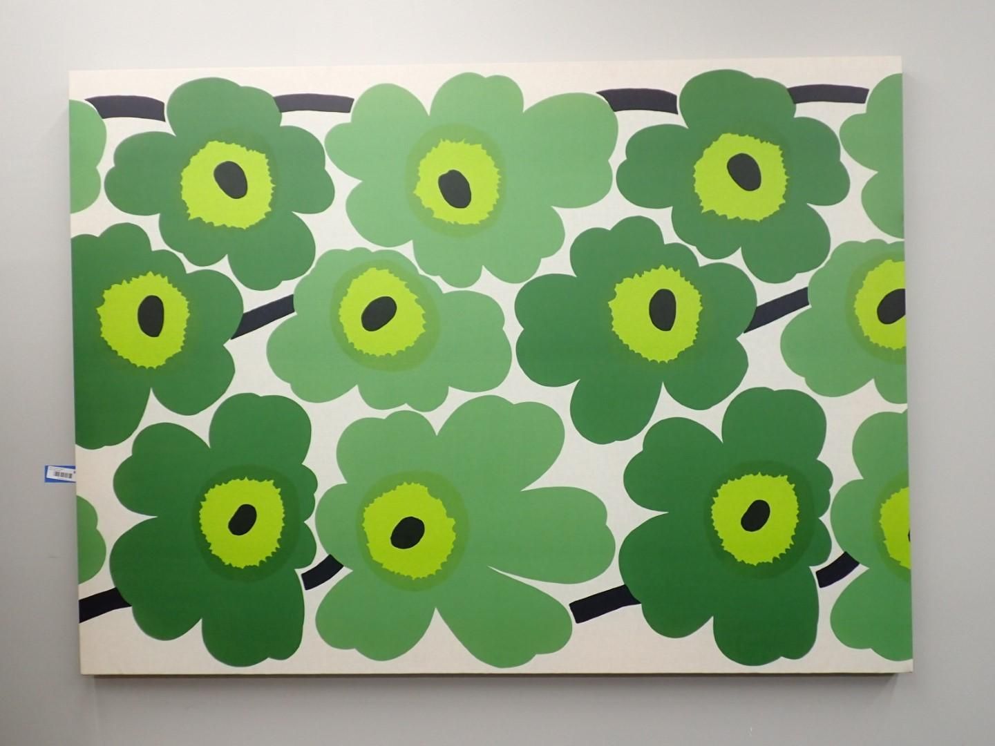 Green floral pattern on a white background, black stems.