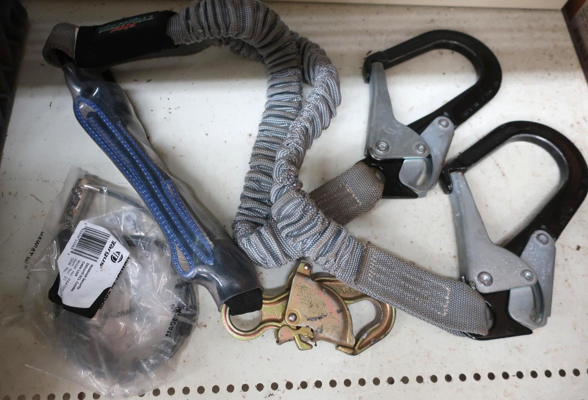 Safety lanyard with two large hooks and a small attachment.