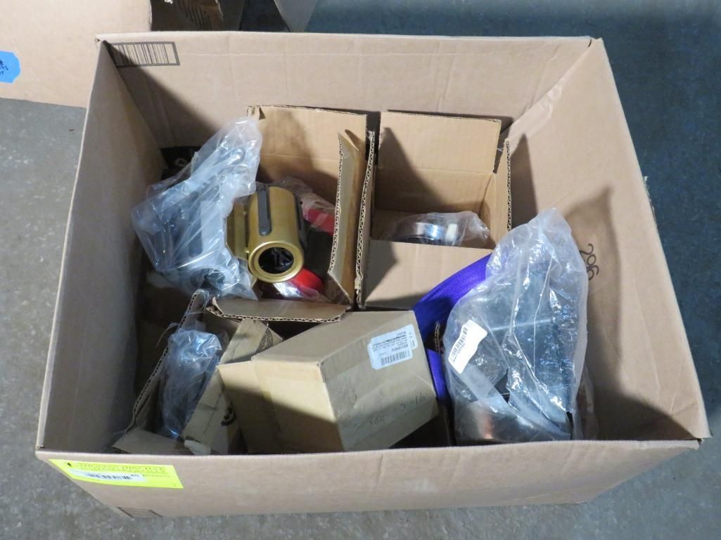 Cardboard box filled with packaged machine parts.