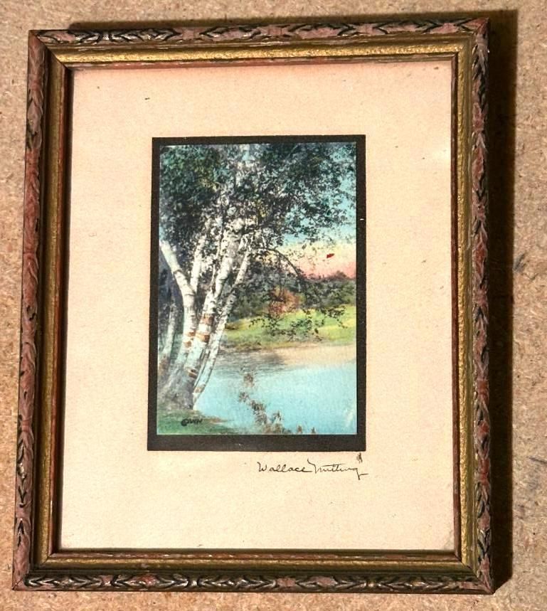 Painting of birch trees by a blue lake, framed in gold.