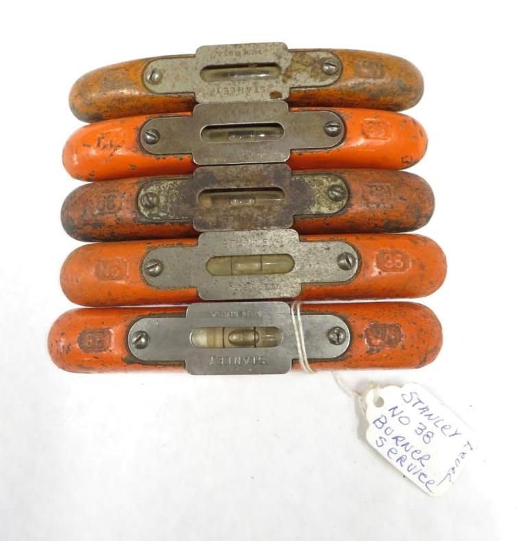 Five vintage Stanley No. 36 Torpedo levels with orange wood handles, stacked.
