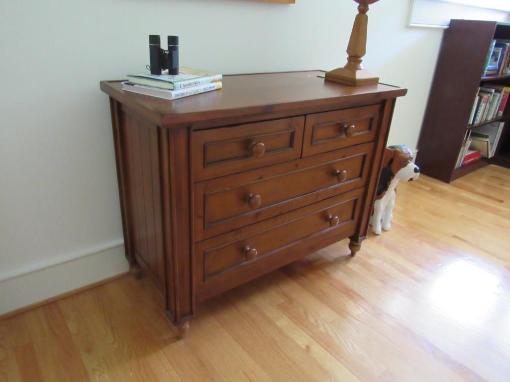 Wooden dresser with four drawers.