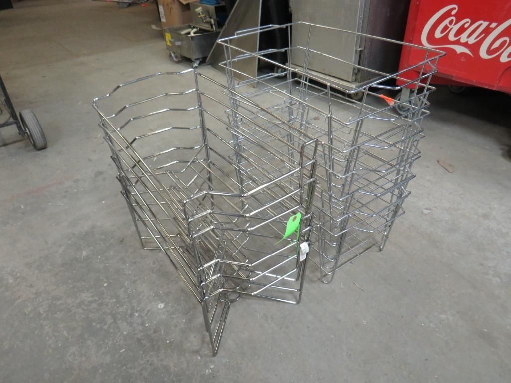 Metal wire storage baskets stacked on a concrete floor.