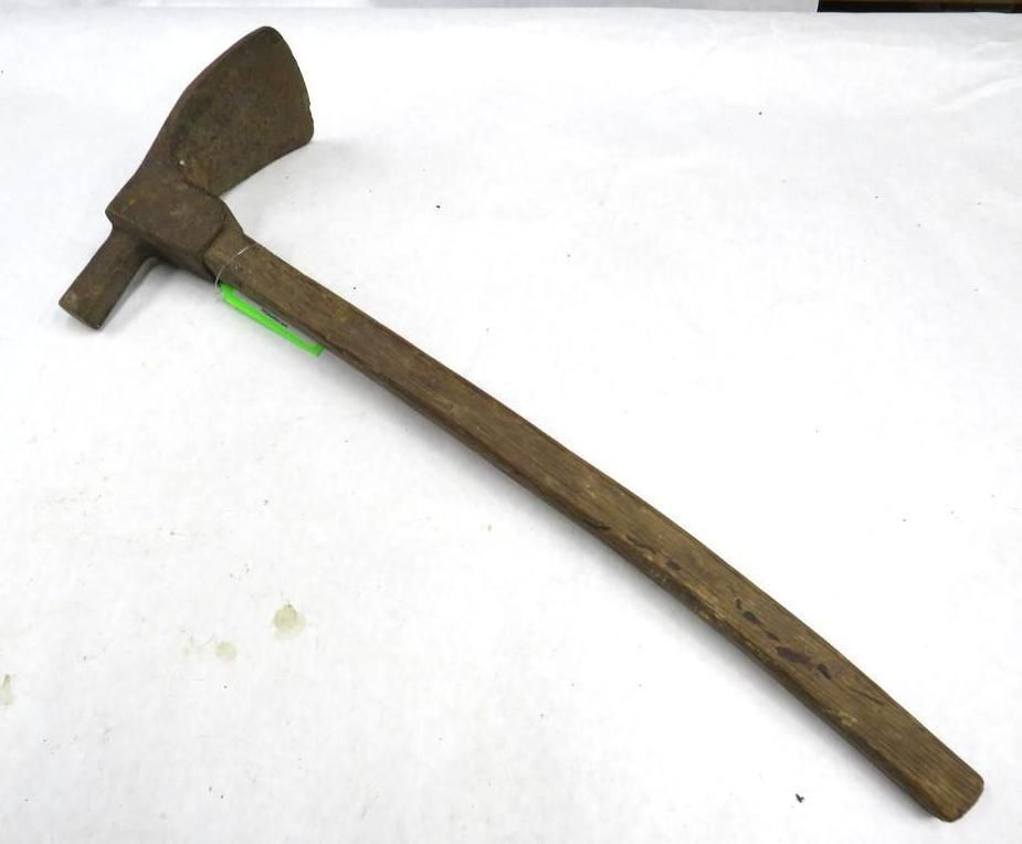 Old, metal adze with wooden handle; angled blade and flat top.
