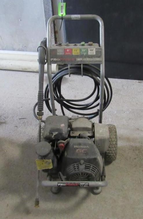 Pressure washer with black hose and motor, controls on top bar.