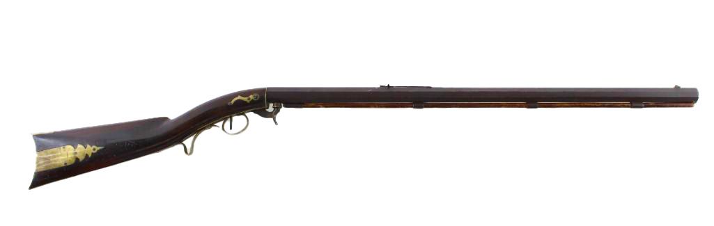 Antique rifle, dark wood with ornate gold detail.