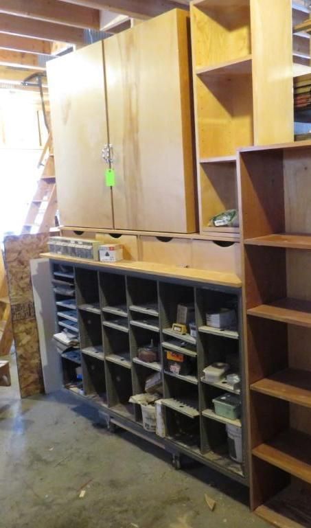Wooden cabinets and shelves in a workshop, containing various tools and supplies.