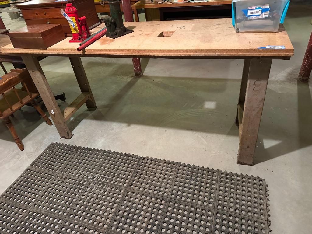A wooden workbench with tools and supplies.