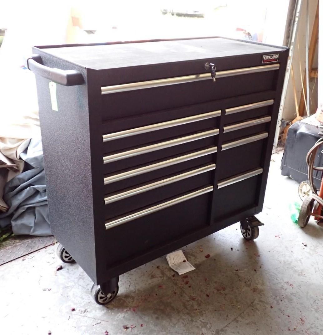 Black tool chest on wheels with multiple drawers and a locking top.