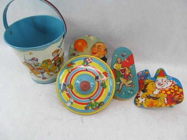 Vintage toys: tin bucket, top, and wooden cutouts with cartoon figures.