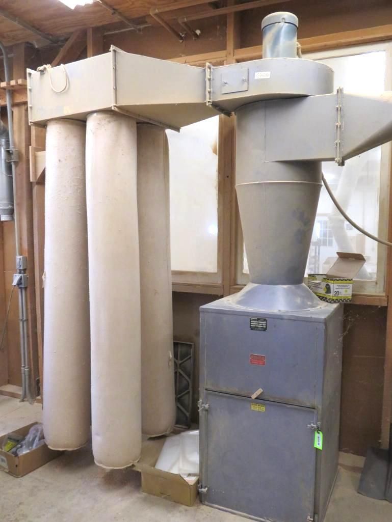 Dust collection system with three long fabric filter bags and a metal unit.