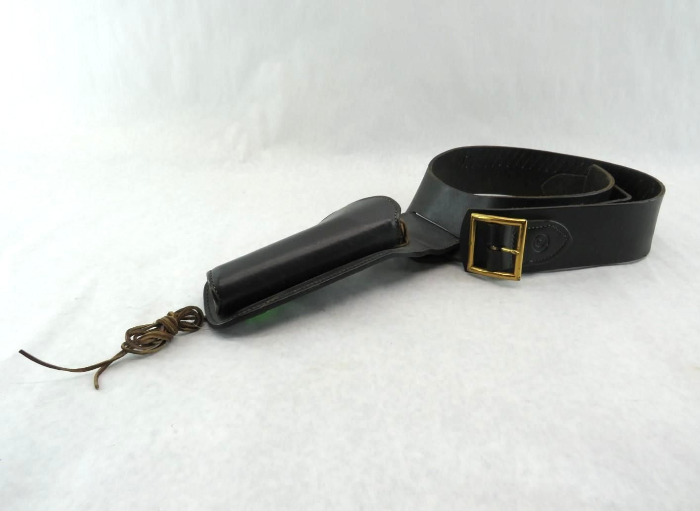 Black leather rifle sling with brass buckle, leather holder, and knotted cord.