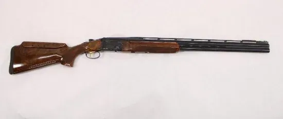 Shotgun on a white background, brown wooden stock and forend.