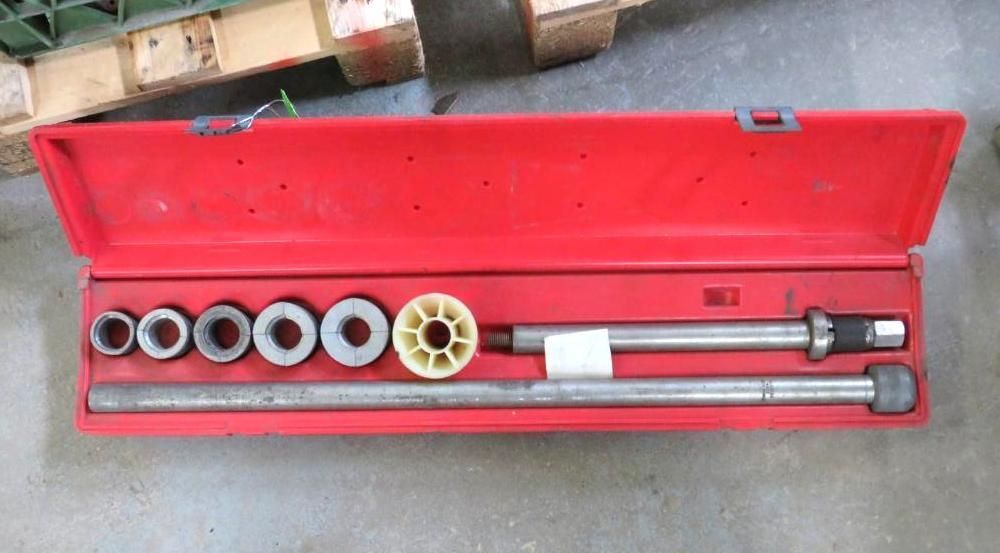 Red toolbox containing various metal tools, likely for mechanical work.