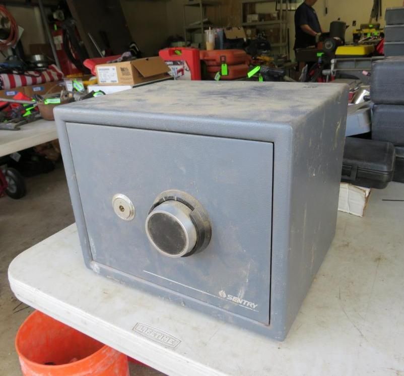 Gray Sentry safe on a white table.
