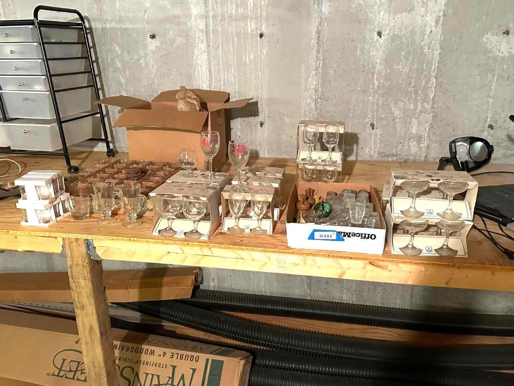 A workbench with various boxes and objects in a basement setting.