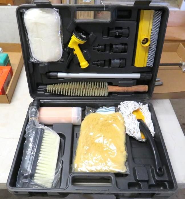 Black case open, containing car wash tools: spray nozzle, brushes, sponge, squeegee, and attachments.