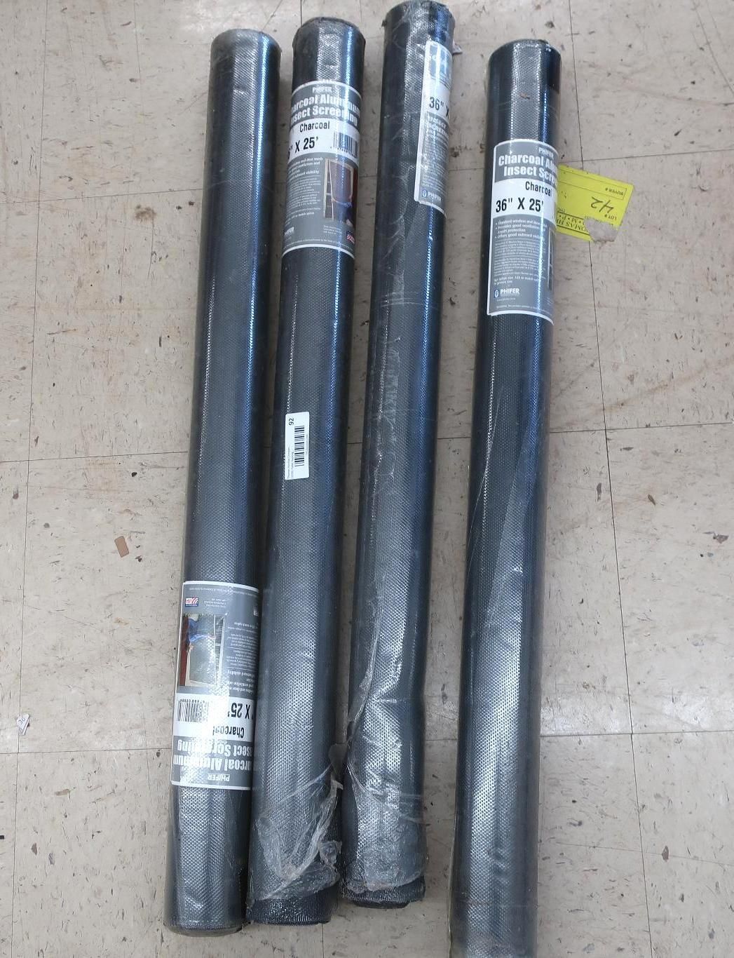 Four rolls of black wire mesh, vertically arranged on a light-brown surface. Each has a product label.