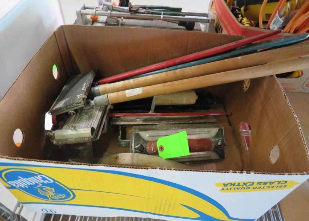 Cardboard box holding assorted construction tools.