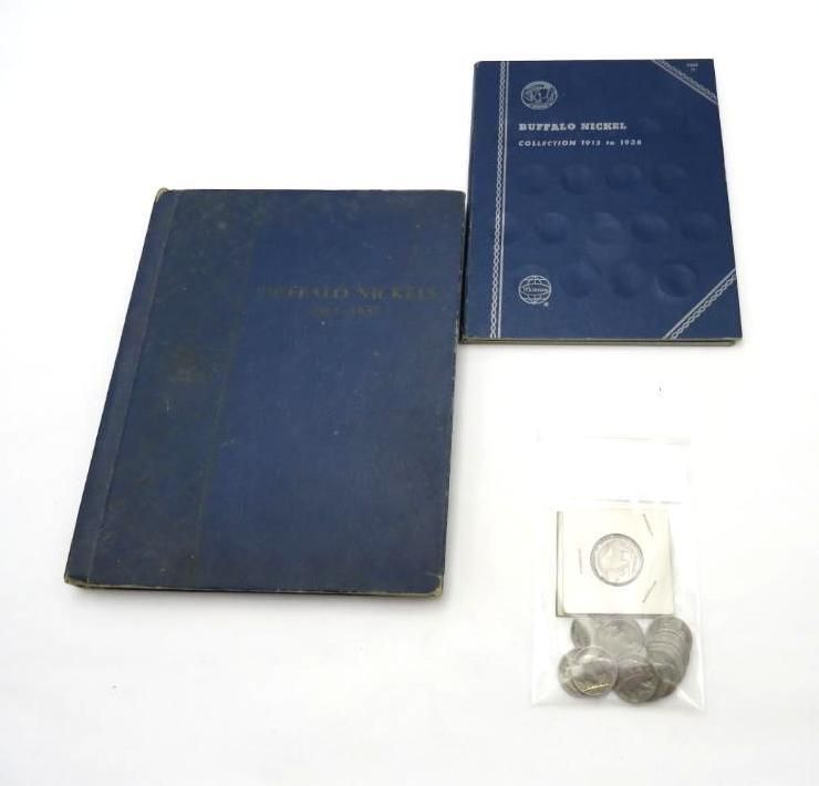 Blue coin albums and a bag of coins on a white surface.