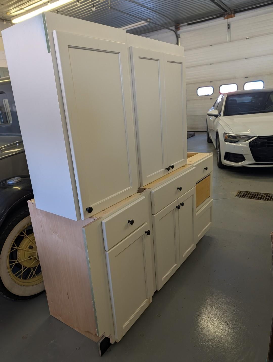 White kitchen cabinets in a garage.