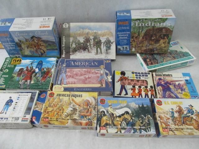 Various boxed toy sets depicting historical scenes and figures, including soldiers and Native Americans.