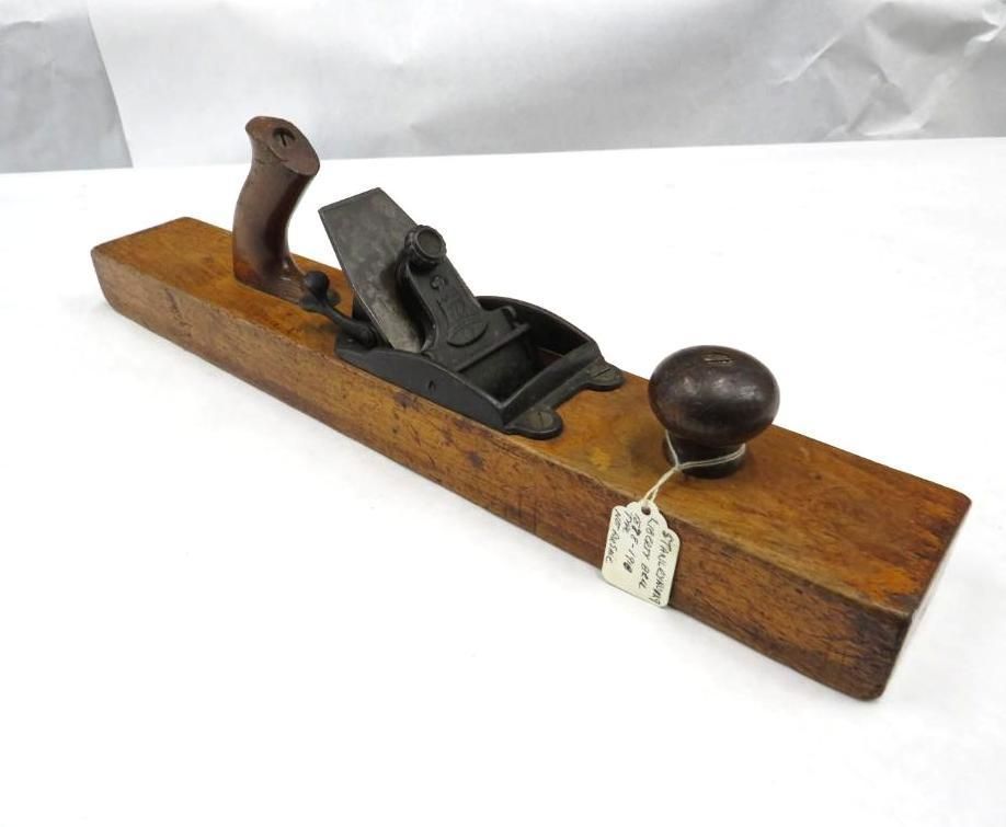 Wooden smoothing plane tool with dark wooden handle and knob.