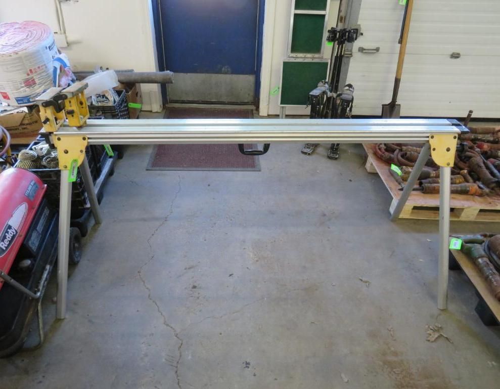 Sawhorse with silver track, yellow supports, and metal legs, set indoors.