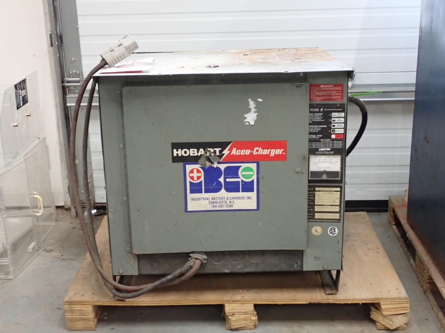 Hobart Auto Charger on wooden pallet, gray metal box with attached cables and gauges.