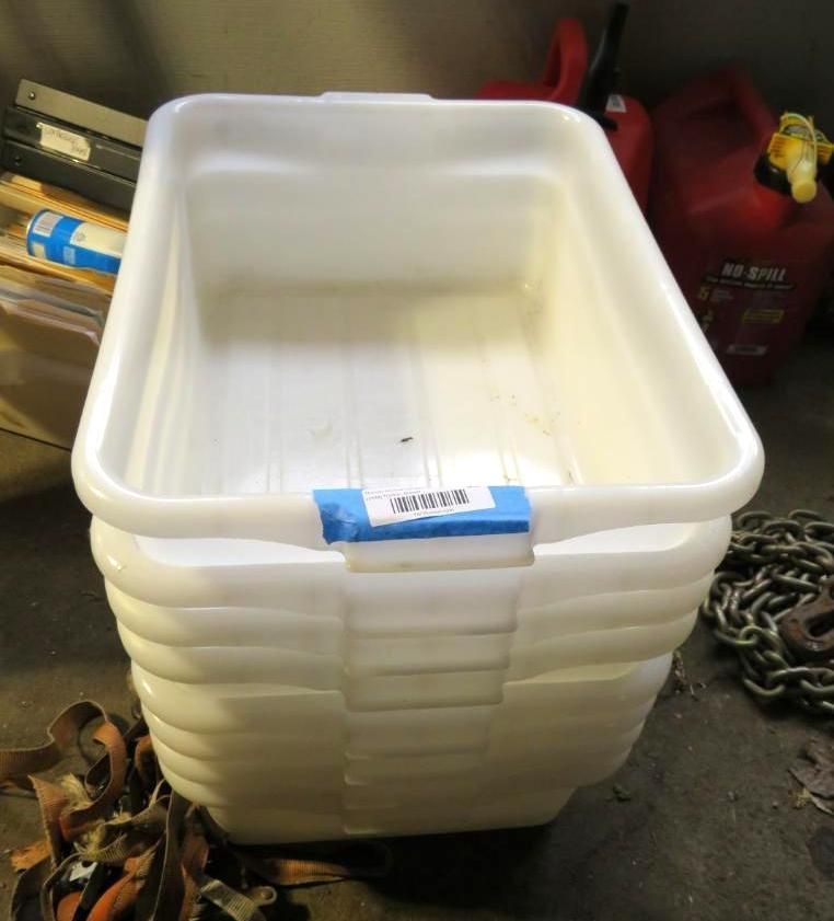 Stack of white plastic bins, with a red gas can and chains visible.