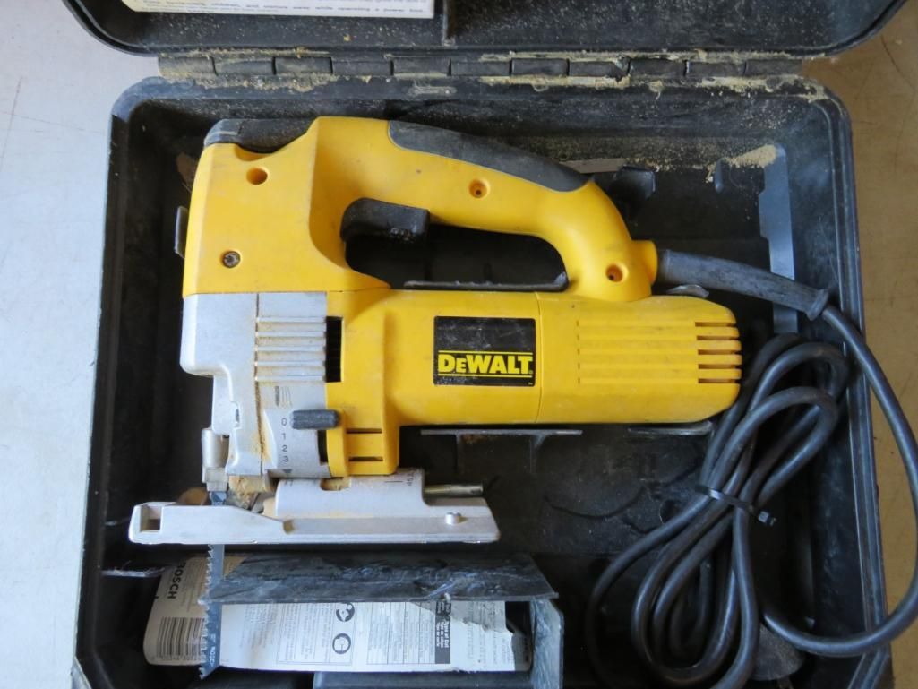 Yellow and gray DeWalt jigsaw inside a black carrying case with a coiled black power cord.