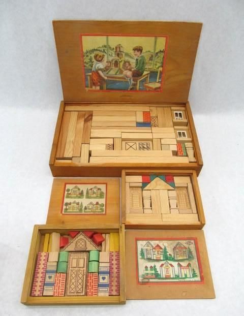 Wooden toy building blocks in a box with illustrations of houses and children.