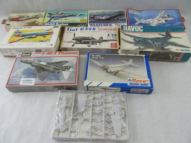 Several model airplane kits with boxes. Some boxes are open with plastic parts visible.