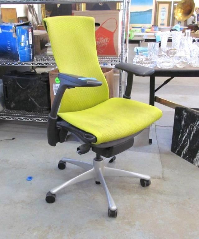 Yellow office chair with silver base, black armrests, and a yellow seat and back.