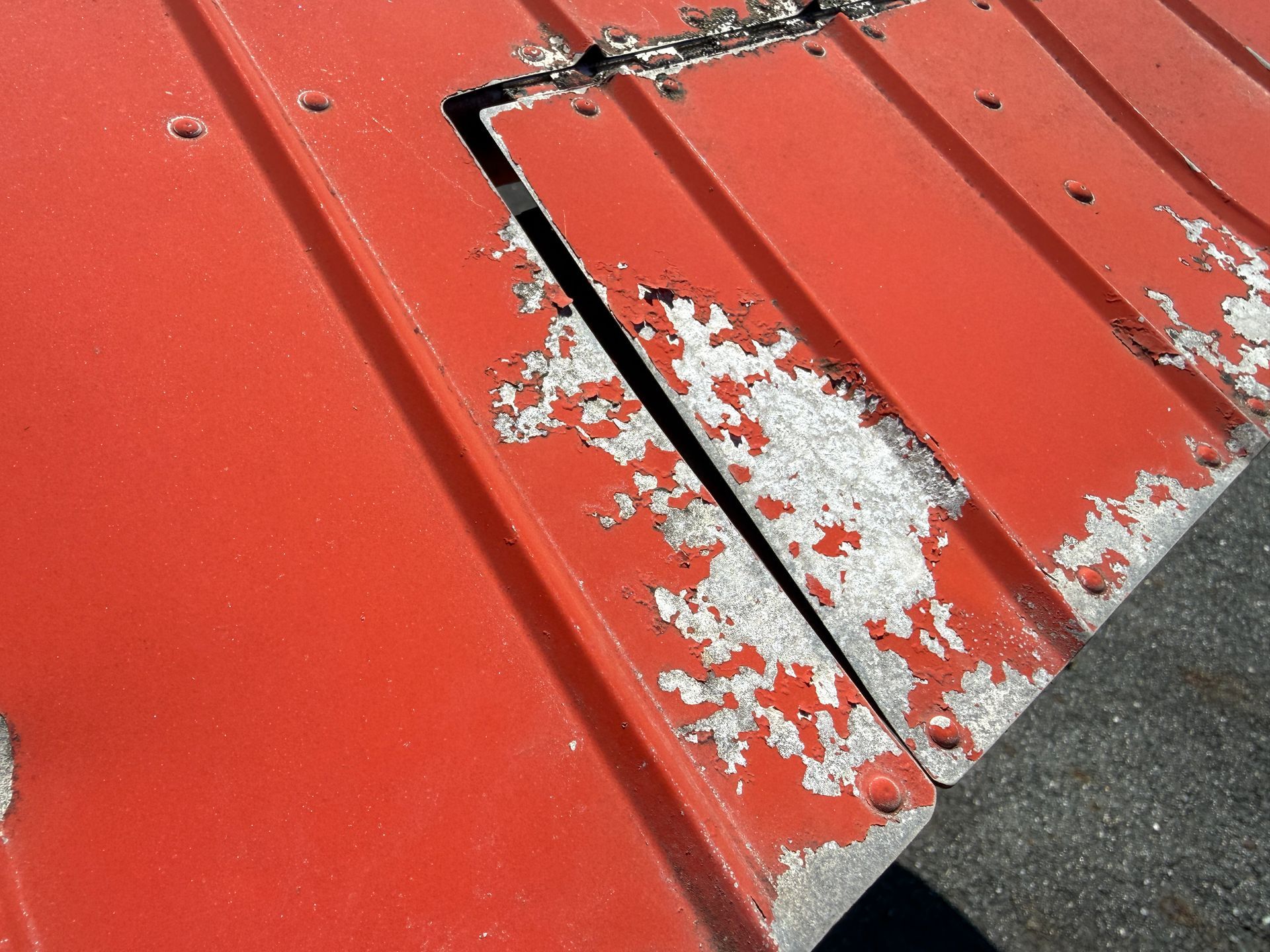 Red painted metal airplane wing
