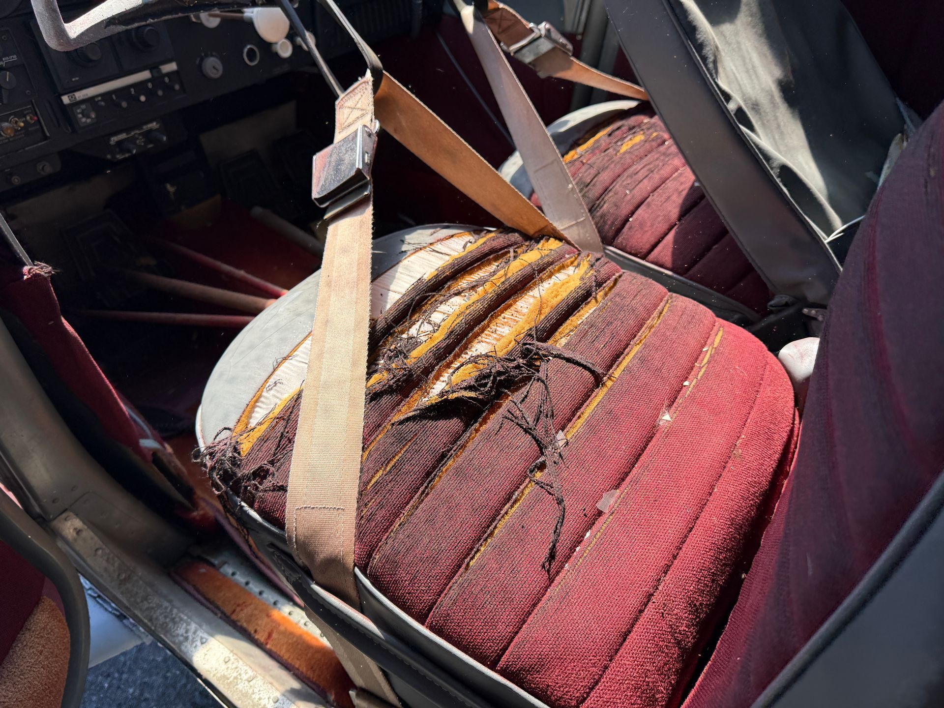 Red-and-white striped airplane seat upholstery inside a plane interior