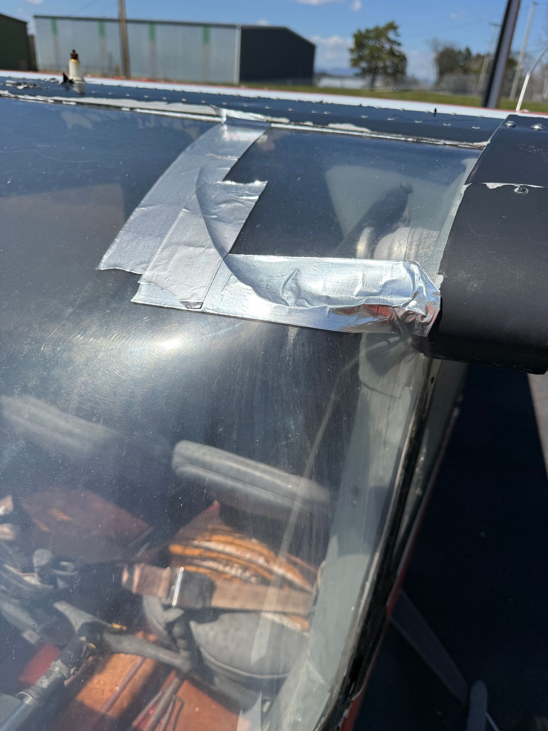 Close-up of a plane windshield with some damage