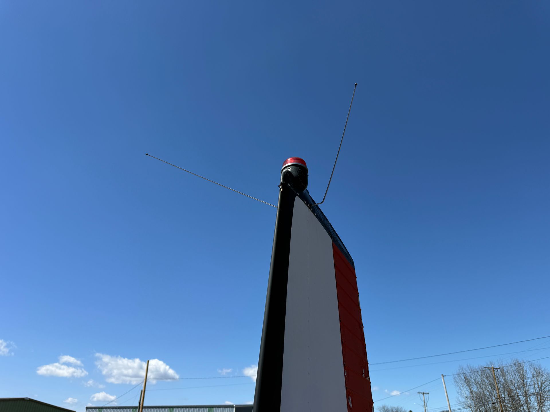 Tall black and red plane tail with antenna