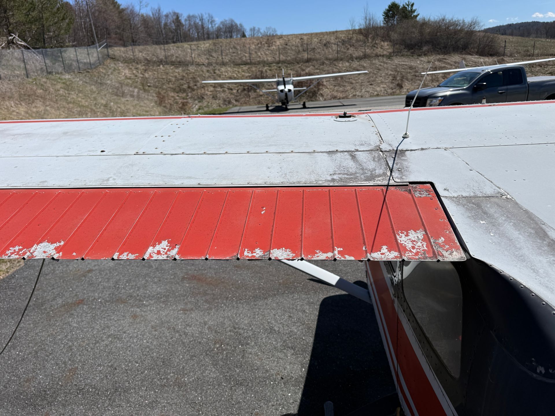 Airplane wing with red and gray panels